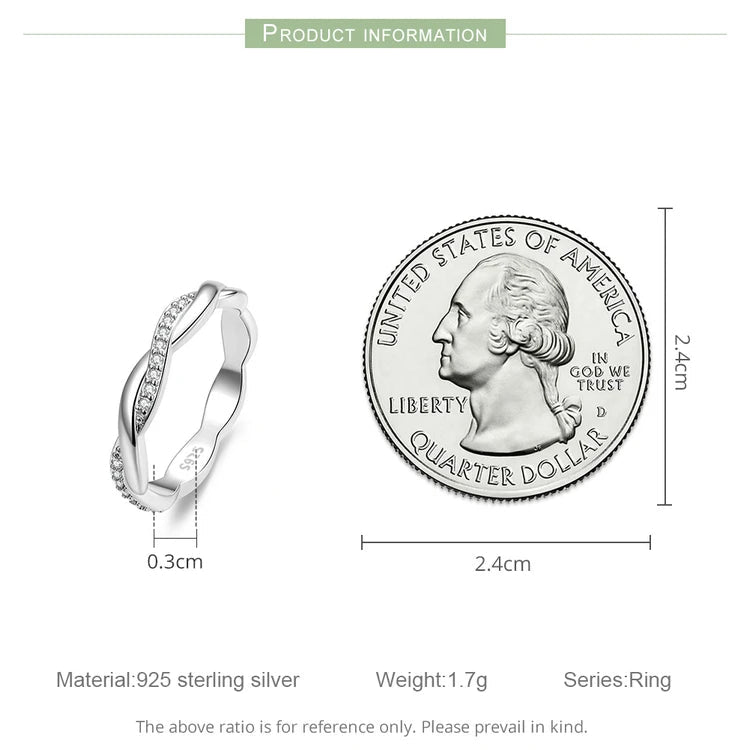Silver ring with diamond accents next to a U.S. quarter dollar coin for size comparison on a white background.