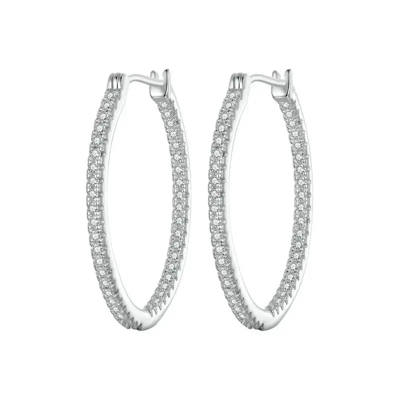 A pair of silver hoop earrings paved with small clear stones, shown against a plain white background.