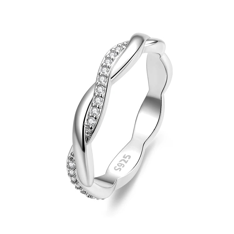 Silver ring with diamond accents on a white background