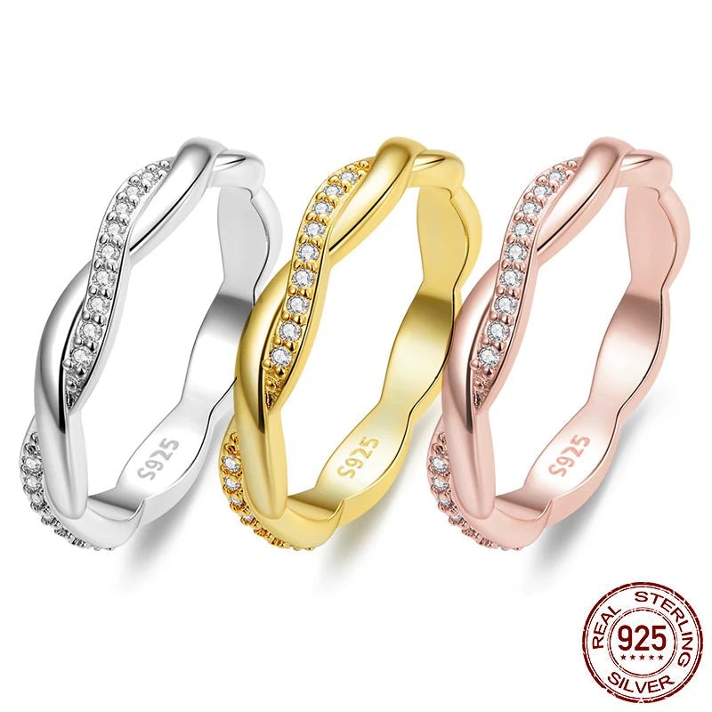 Three twisted band rings with rows of clear stones, shown in silver, yellow gold, and rose gold. The inner band is marked S925, and a 'REAL STERLING 925 SILVER' emblem is in the bottom right corner.