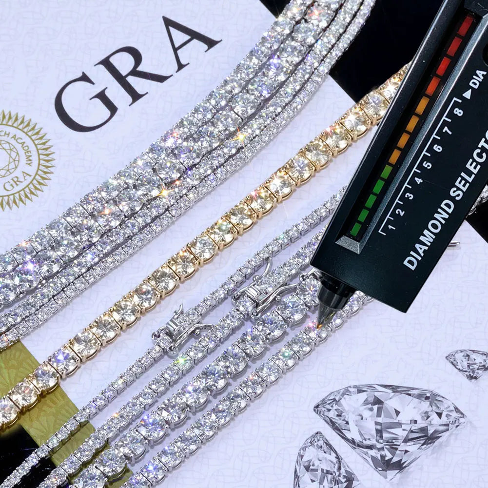 Diamond bracelets on a white surface with a diamond quality tester and 'GRA' branding.
