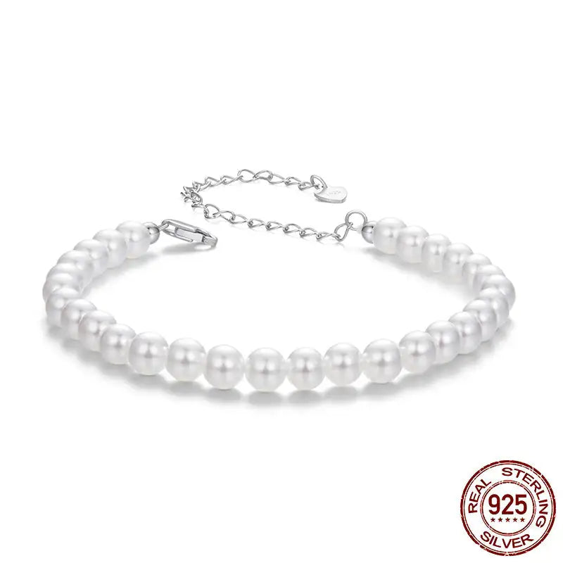 Pearl bracelet with silver clasp on a white background, featuring 'Real Sterling Silver 925' stamp.