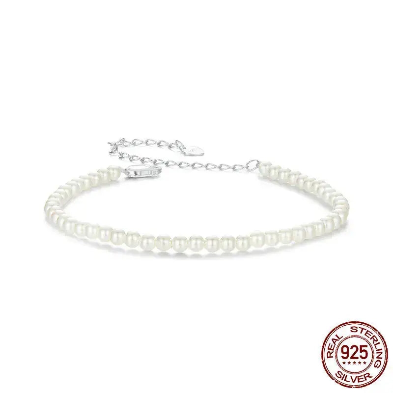 Pearl bracelet with silver clasp on a white background, featuring 'Real Sterling Silver 925' stamp.