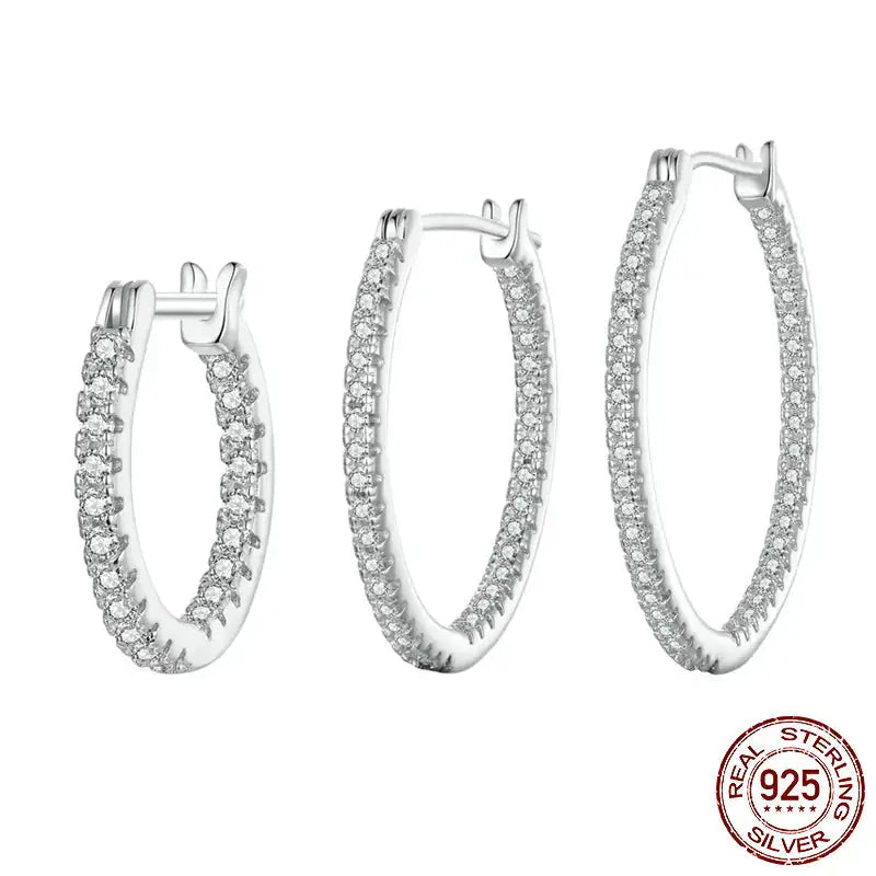 A set of three hoop earrings made of 925 sterling silver with zircon inlays, presented in varying sizes with a '925 Sterling Silver' stamp in the image.