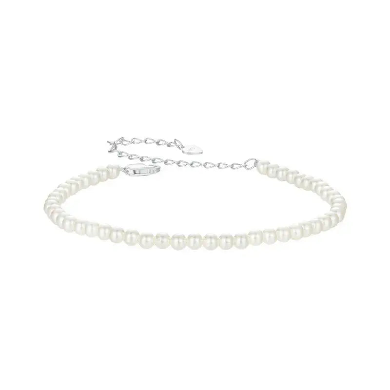 A white, round, pearl bead bracelet with a silver clasp, marked with '925 Sterling Silver' and a 'REAL Sterling Silver 925' stamp.
