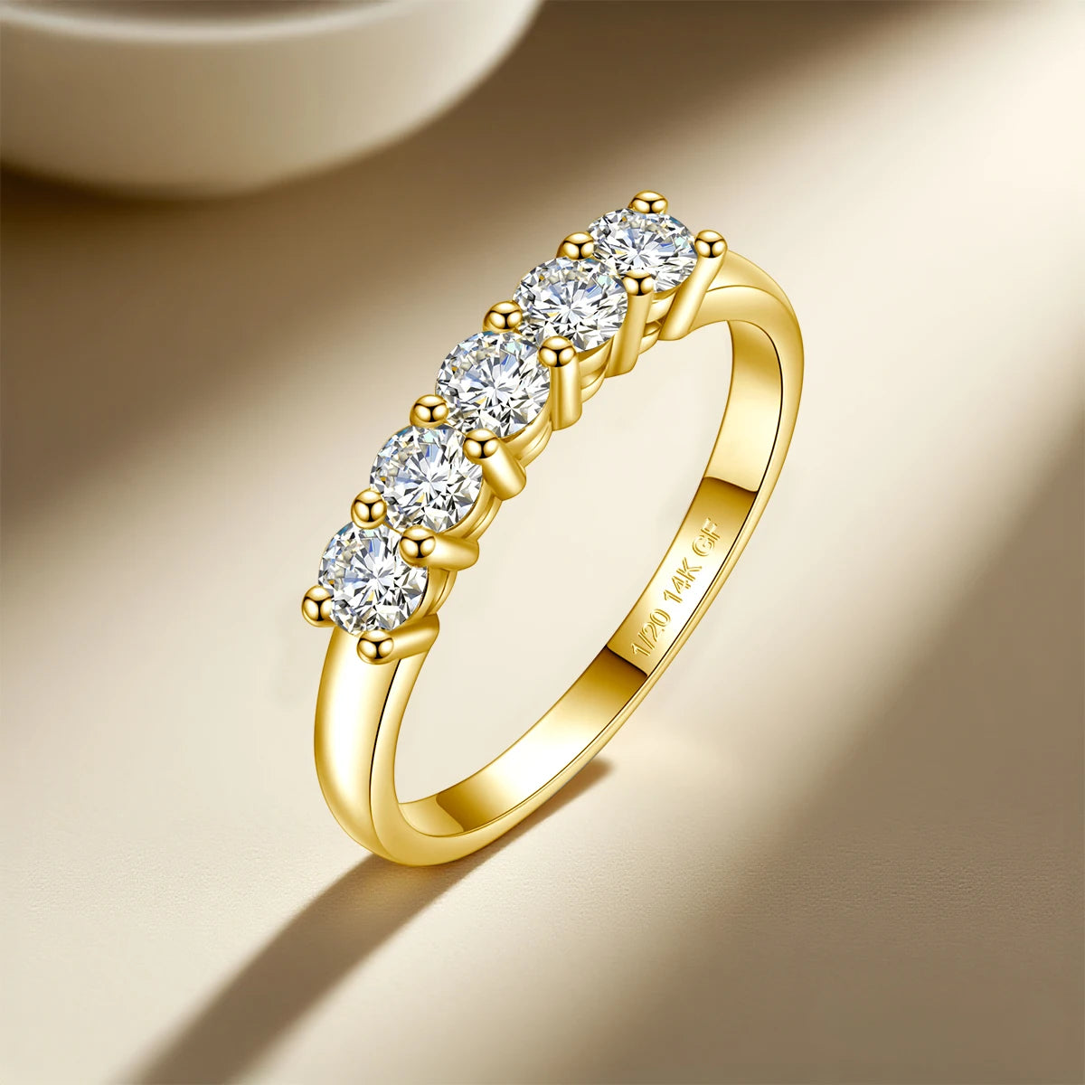 Gold ring with diamonds on a beige background