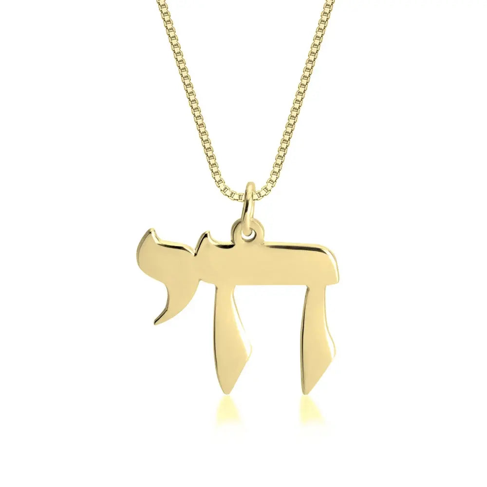 Gold necklace with a unique pendant on a white background