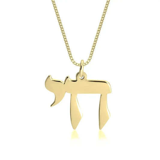 Gold necklace with a unique pendant on a white background