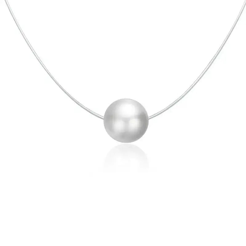 A delicate silver chain necklace featuring a single, smooth, lustrous white pearl pendant, shown against a clean white background with a soft reflection below.